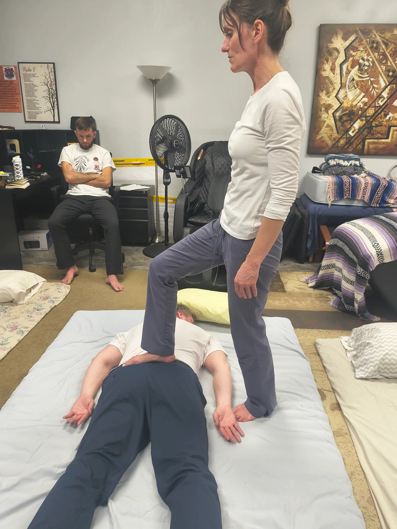 Students practicing supine leg work on Thai mats